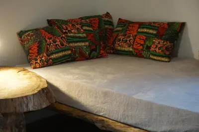 a bed with two pillows on top of it at Africa Amini Homes - Africa Amini Life in Nkoaranga