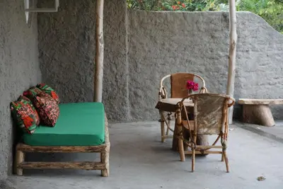 a room with two chairs and a table and a bench at Africa Amini Homes - Africa Amini Life in Nkoaranga