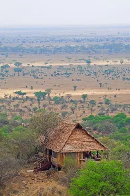 an old hut in the middle of a field at Serengeti Pioneer Camp in Mugumu
