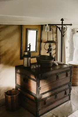 a bathroom with a sink on top of a wooden chest at Serengeti Pioneer Camp in Mugumu