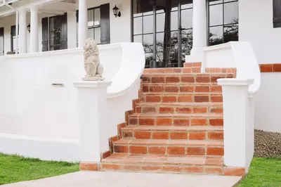 a stone statue on the steps of a house at Kili Seasons Hotel in Arusha