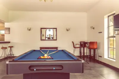 a pool table in the middle of a room at Kili Seasons Hotel in Arusha