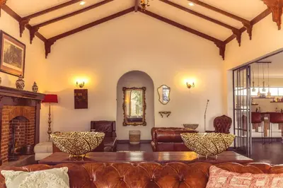 a living room with a couch and a fireplace at Kili Seasons Hotel in Arusha