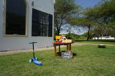 a table with a sign on the grass next to a building at Kili Seasons Hotel in Arusha