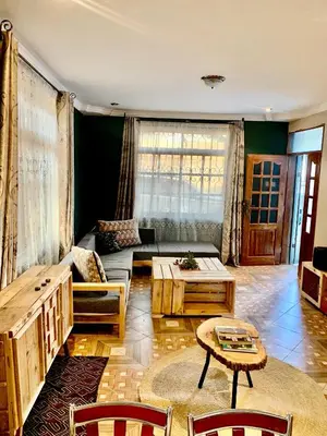 a living room with a couch and a table at we are one apartment in Arusha