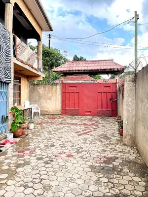 a red garage with a red door on a house at we are one apartment in Arusha
