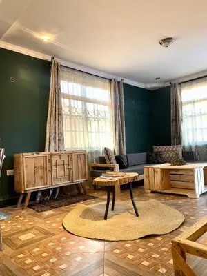 a living room with a couch and a table at we are one apartment in Arusha