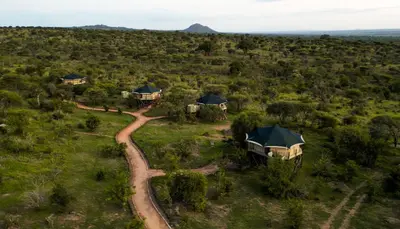 an aerial view of a house in the middle of a field at TARANGIRE KURO TREETOP LODGE in Manyara