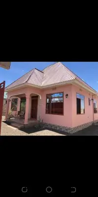 a small pink house with a roof at Zimbe Host Arusha in Arusha