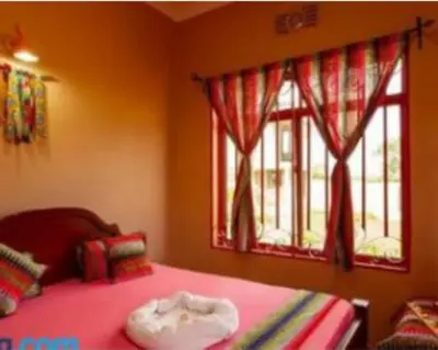 a bedroom with a bed and two windows at Zimbe Host Arusha in Arusha