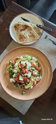 a plate of food with a salad and a tortilla at Manyada Inn in Arusha