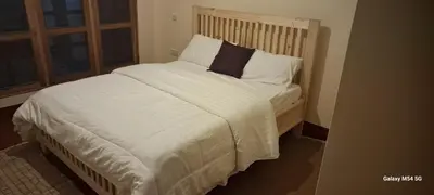 a bedroom with a large bed with white sheets and pillows at Manyada Inn in Arusha