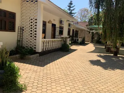 a brick walkway in front of a house at Manyada Inn in Arusha