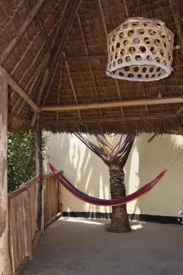 a hammock tied to a tree in a building at Stasumo House Arusha in Arusha