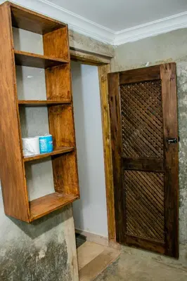 a wooden cabinet with a door in a room at Blue elephant villas in Arusha
