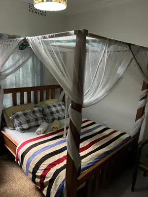 a bedroom with a bed with a canopy at Blue elephant villas in Arusha