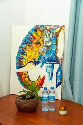 a painting of a lion with two bottles of water at Blue elephant villas in Arusha