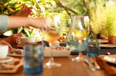 a table with food and glasses of wine at Katambuga House in Arusha
