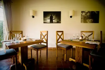 a dining room with two wooden tables and chairs at Katambuga House in Arusha