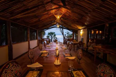 a long dining room with tables and chairs in a restaurant at Kisima Ngeda Camp in Mangola