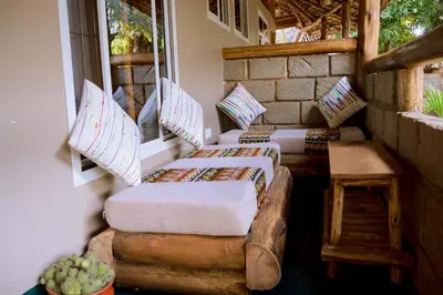 a porch with two couches and a window at Kilimanjaro Scenic Homestay in Moshi