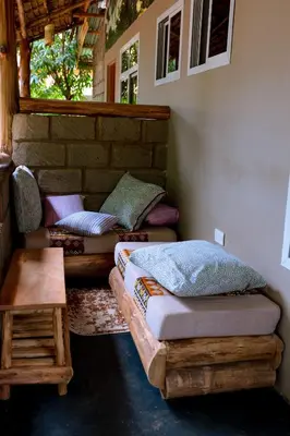 a room with two beds and a table in it at Kilimanjaro Scenic Homestay in Moshi