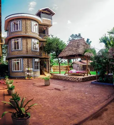 a large brick building with a large yard in front of it at Kilimanjaro Scenic Homestay in Moshi