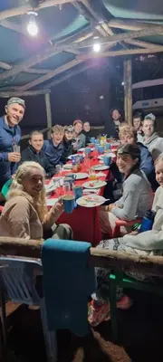 a group of people sitting at a long table at Kisanga Homestay in Moshi