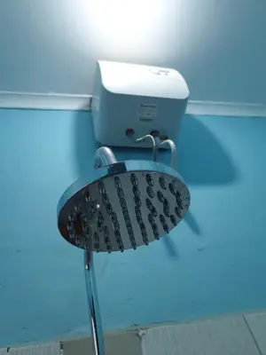 a close up of a toilet in a bathroom at Kisanga Homestay in Moshi