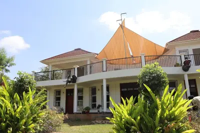 a house with a balcony on top of it at Themi View in Arusha