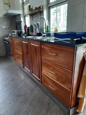 a kitchen with a large counter with a sink at Themi View in Arusha