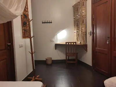 a room with a table and a chair and a desk at Themi View in Arusha
