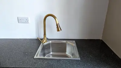 a sink with a faucet on a counter at Mufasa city Apartments in Arusha