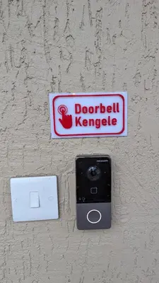 a sign on a wall with a camera on it at Mufasa city Apartments in Arusha