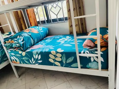 a bunk bed in a room with a bedskirts at Mufasa city Apartments in Arusha