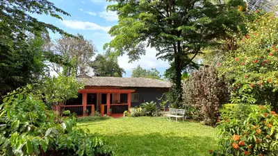 a house in the middle of a yard at Rudi House in Msaranga