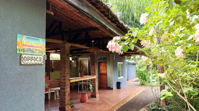 a patio with a table and a sign on a building at Rudi House in Msaranga