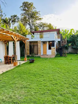 a house with a green yard with a grassy yard sidx sidx sidx at Tiny house with amazing view in Arusha