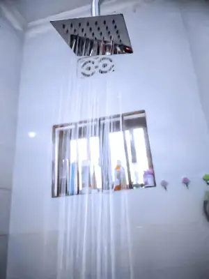 a bathroom with a mirror and a shower curtain at eneyahomes ~ stay with me in Arusha