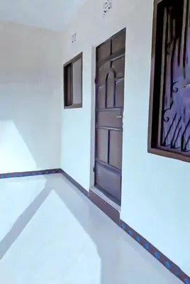 a room with a door and a picture on the wall at eneyahomes ~ stay with me in Arusha