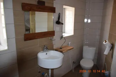 a bathroom with a sink and a toilet at Mwi Village House in Mto wa Mbu
