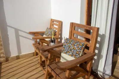 two wooden chairs sitting in a room at Africa Safari Karatu in Karatu