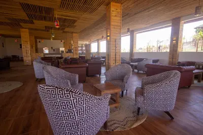 a lobby with chairs and tables in a building at Africa Safari Karatu in Karatu
