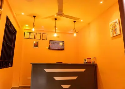 a yellow room with a ceiling fan and a counter at Kiteme Comfort Lodge in Arusha