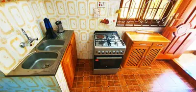 a small kitchen with a stove and a sink at Goodhope 3-Bedroom Vacation Rental in Arusha