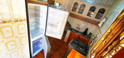 an open refrigerator with its door open in a kitchen at Goodhope 3-Bedroom Vacation Rental in Arusha