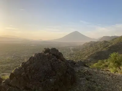 a view of a mountain with a mountain in the distance at Lake Natron Maasai Guesthouse in Mtowabaga