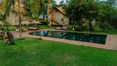 a swimming pool in the yard of a house at Weru Weru River Lodge in Moshi