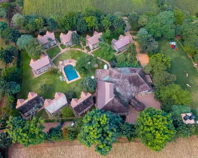 an aerial view of a house with a yard at Weru Weru River Lodge in Moshi