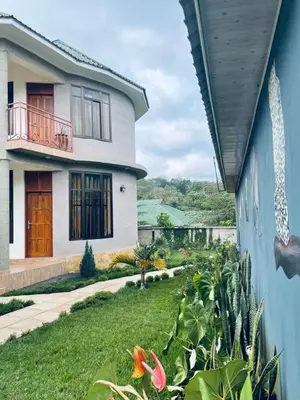 a house with a view of a yard at Wademac Arusha Inn Hotel in Arusha
